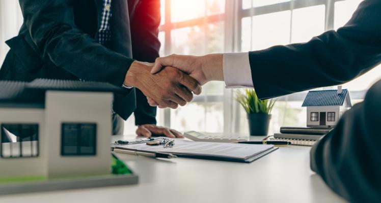 Brokers shake hands.